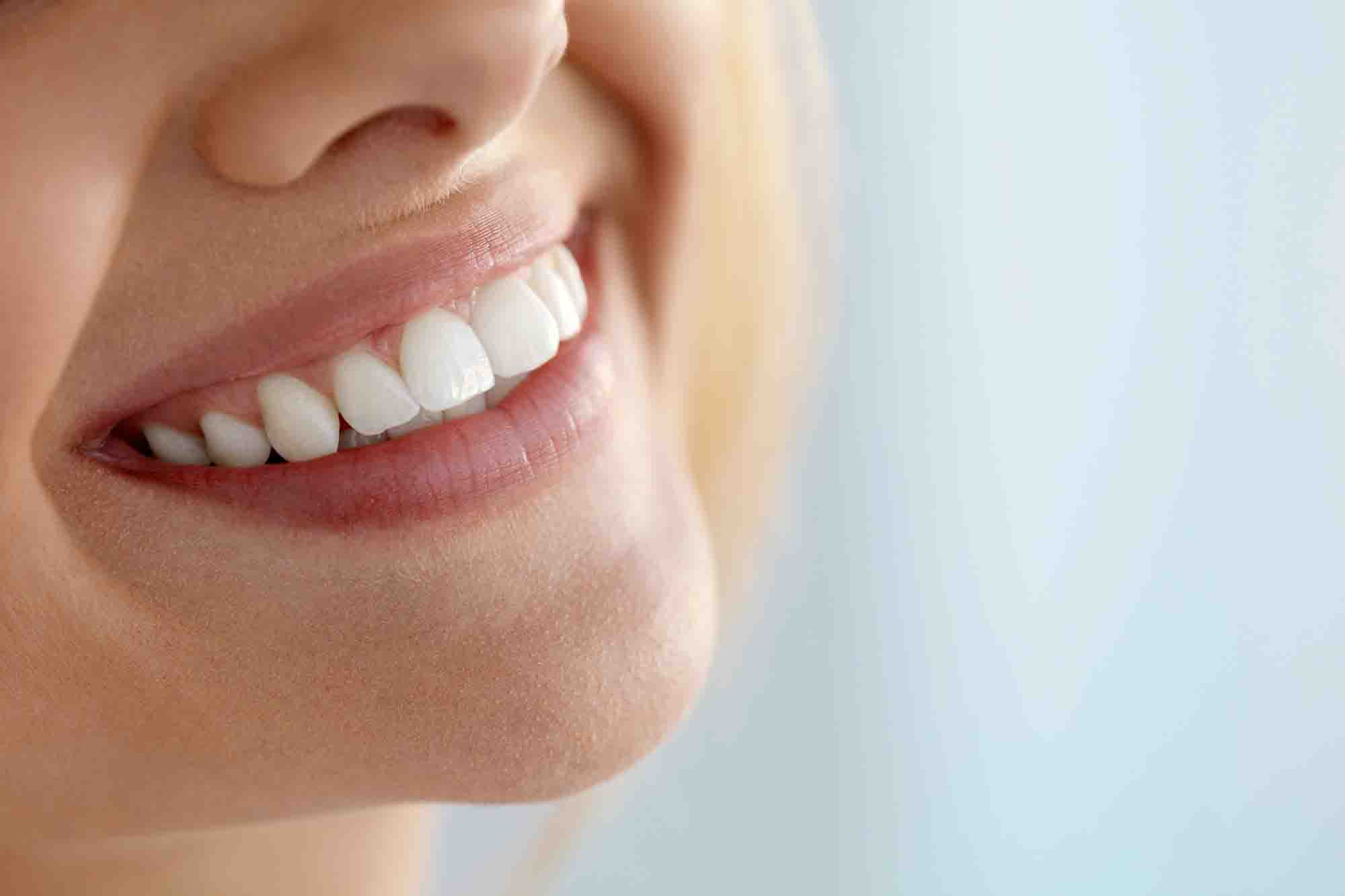 Closeup Of Beautiful Smile With White Teeth. Woman Mouth Smiling